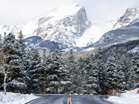 road in foreground and snowcapped mountain in background