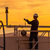 man on pipeline at sunset